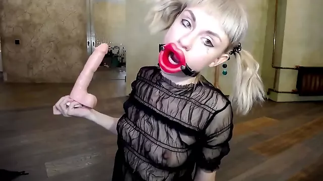Russian girl fucks herself in the throat with a rubber dick